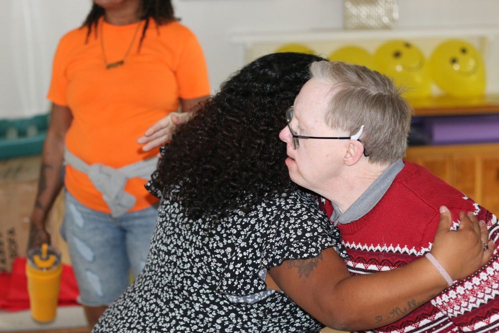Gabriel Homes resident (right) hugging staff (left).