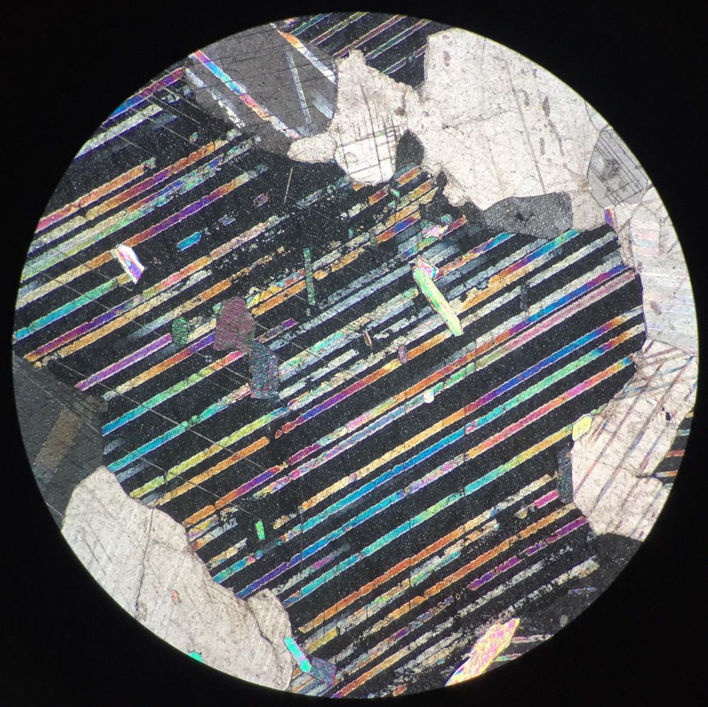 Calcite in thin section, source: https://www.reddit.com/r/geology/comments/fh269j/calcite_under_the_microscope/