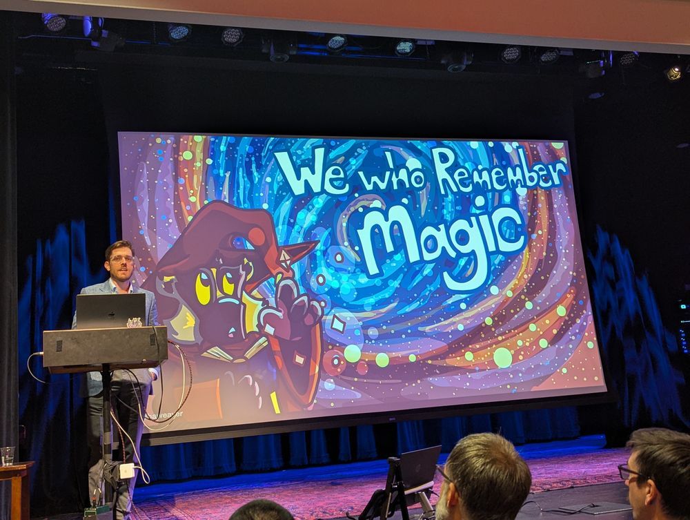 Brandon Weaver on stage with first slide showing an artistic magical background