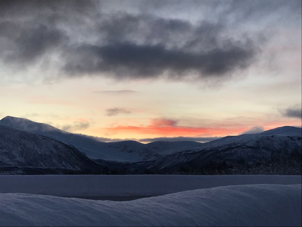 Sunrise over snowy hills seen from the UiT Capmus