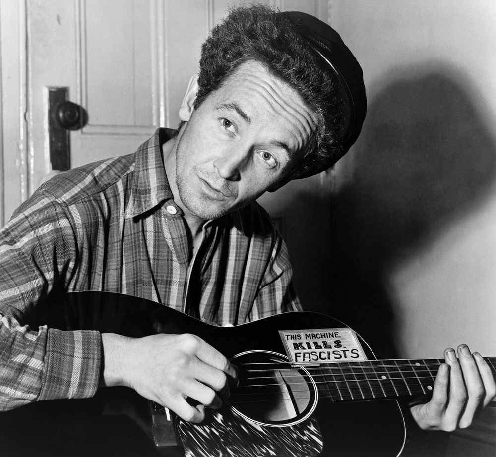 “This machine kills fascists” label on Woody Guthrie’s guitar.