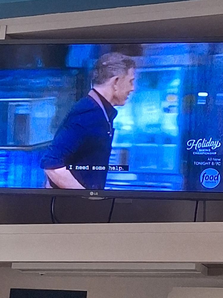 Bobby flay running. Closed caption is of Carson Cressley sayng I need some help.