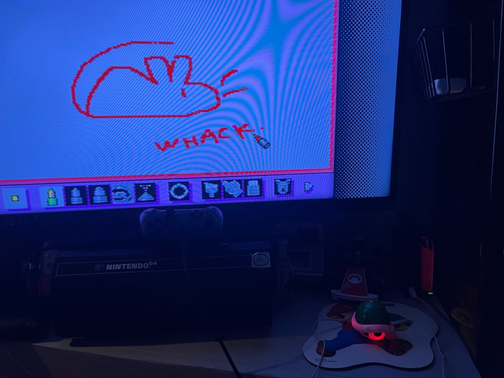 A doodle of a rat on Mario Paint, with "WHACK." written underneath.
Aside it is the USB koopa shell mouse.