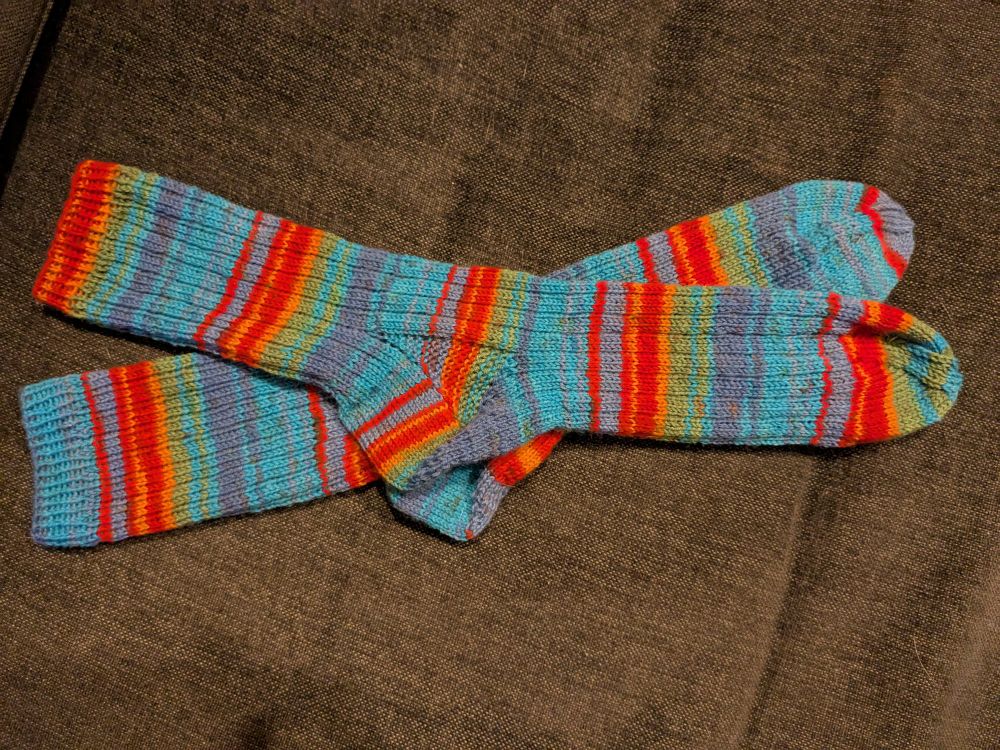 Knitted socks with blue, red, orange and green stripes 