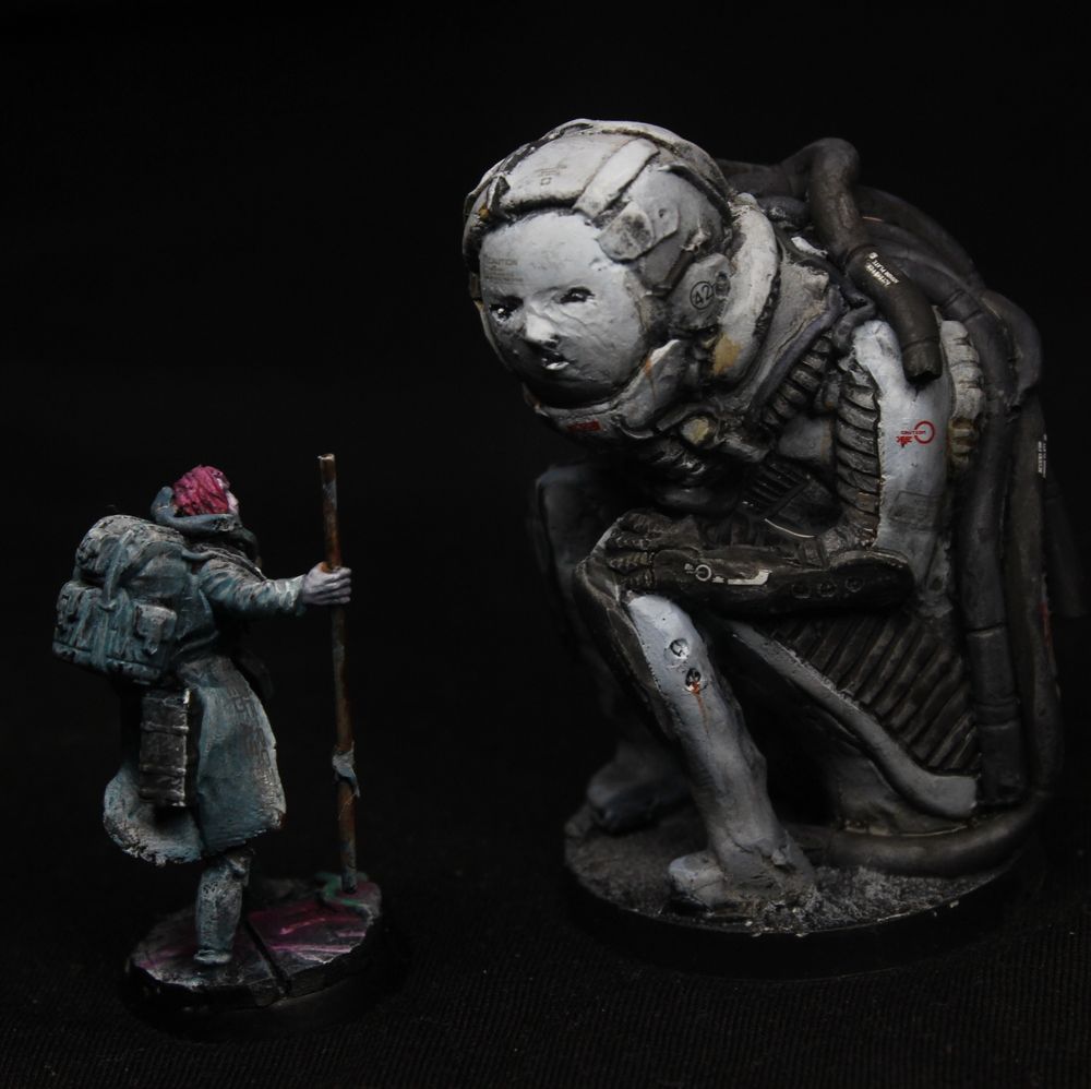 A large biomechanoid, largely monochrome, sitting on the ground in from of a traveller.