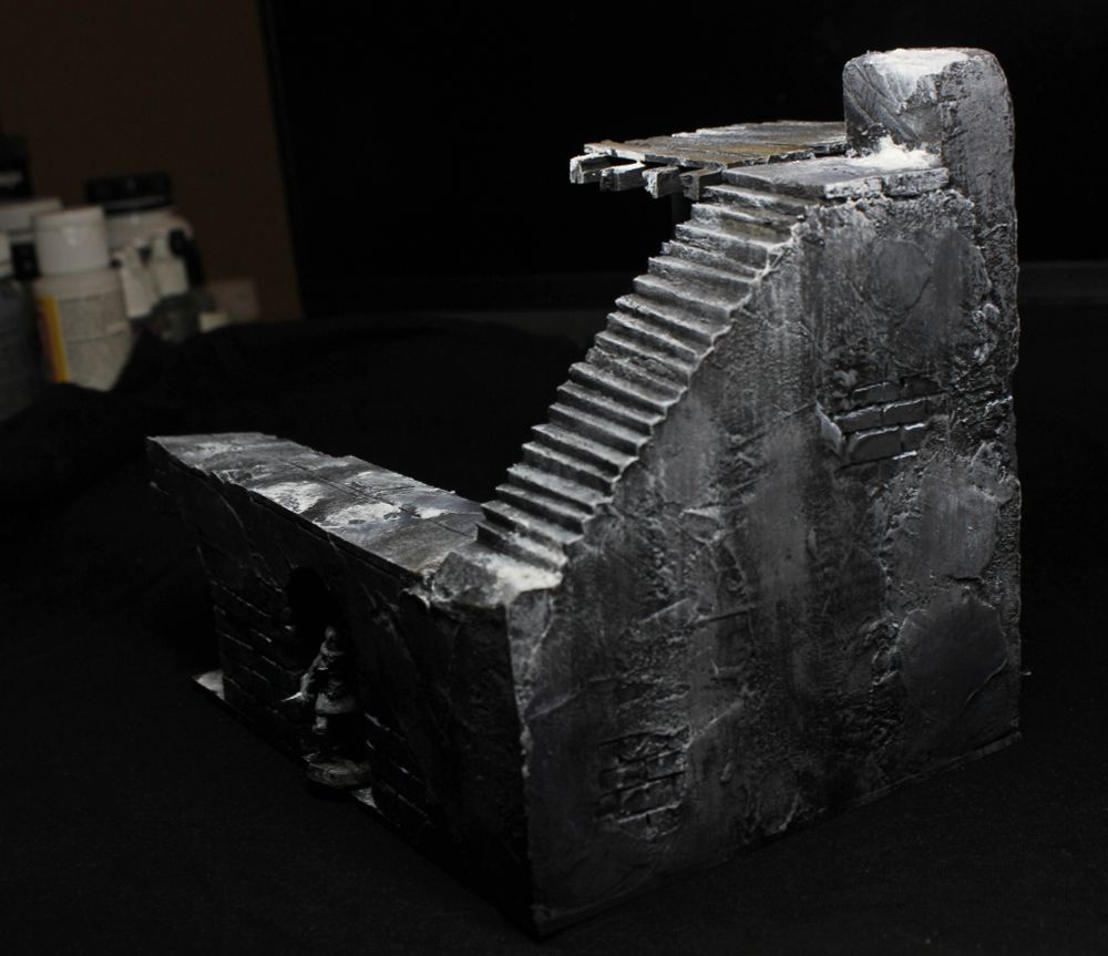 View from the side of the upper staircase, showing a solid wall all the way beneath it.