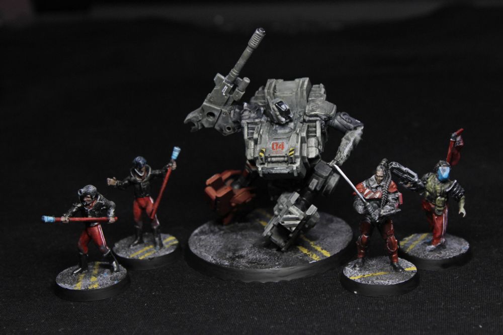 Five figures - four people and a large robot.
All have a strong red element, and either black or military olive to go along with it.