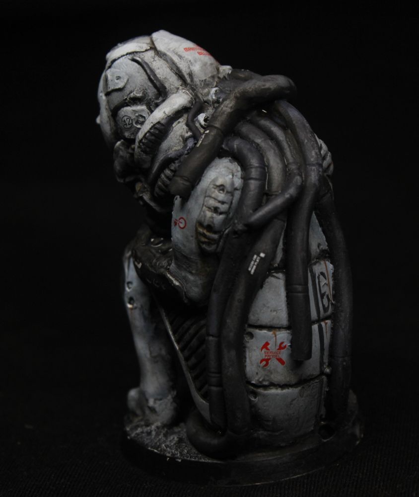View from the back.
This character has a lot of heavy cables coming from the back of their neck. The cables are dark.