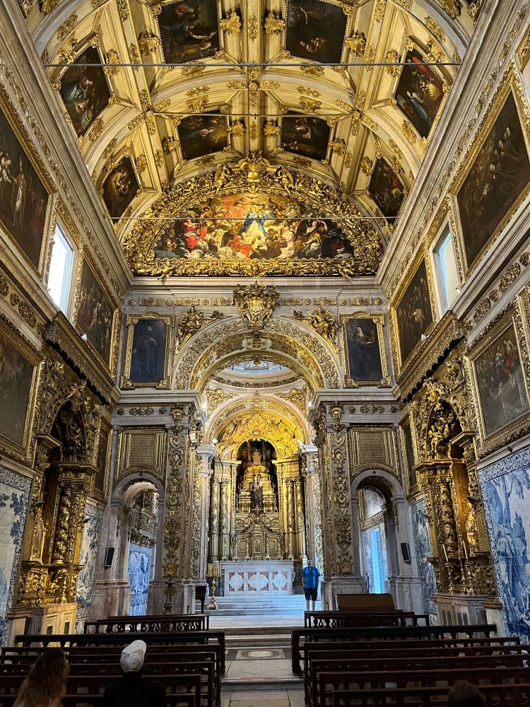 The convent church, view looking slight upwards to above the altar. The church is decorated with gilded surfaces, blue painted tiles and baroque looking paintings.