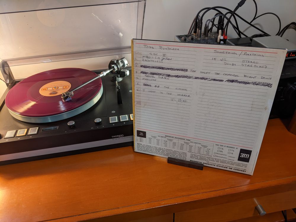 inner LP album covers featuring shots of studio master tape box
next to colored bearsville vinyl spinning on thorens turntable
