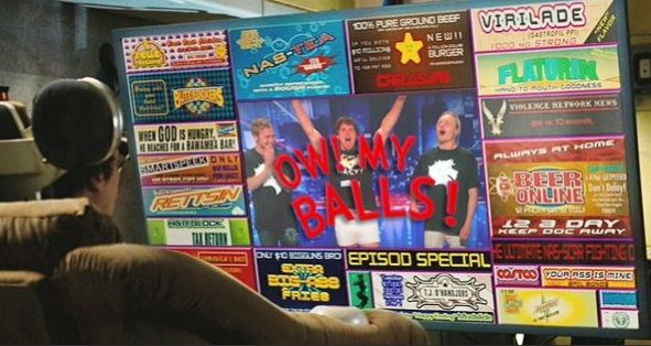 Screen capture from Idiocracy (2006), showing a character watching the popular TV show "Ow! My Balls!" surrounded by advertisements