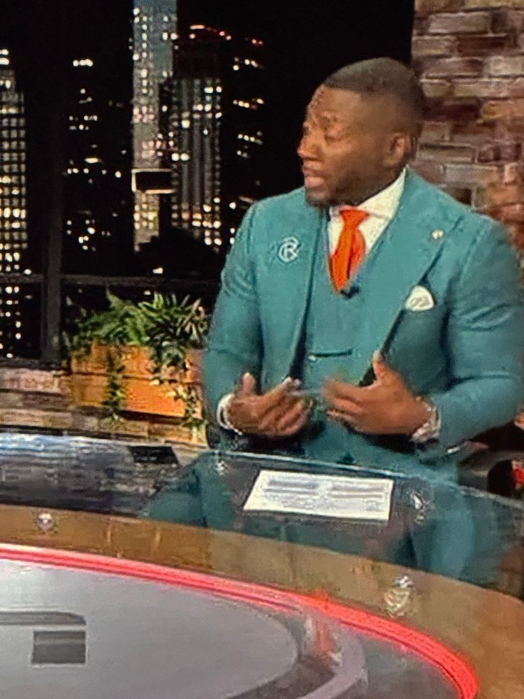 teal suit and orange (glittery?) tie on Ryan Clark on espn