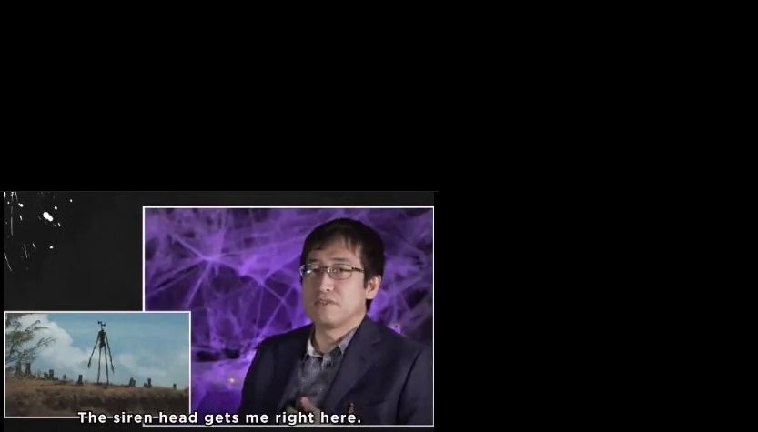 Junji Ito with a picture of Siren Head, a monster i created. He's saying "The Siren Head gets me right here." and is gesturing to his heart.