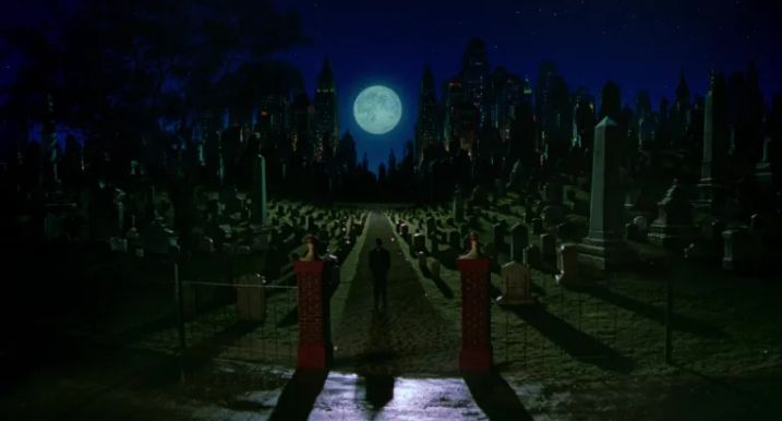 Just an utterly gorgeous matte painting of a green cemetery, curving off in either direction. The sky is night blue and there's a huge moon. A figure stands center frame, his shadow thrown out behind him in the moonlight. From DICK TRACY.