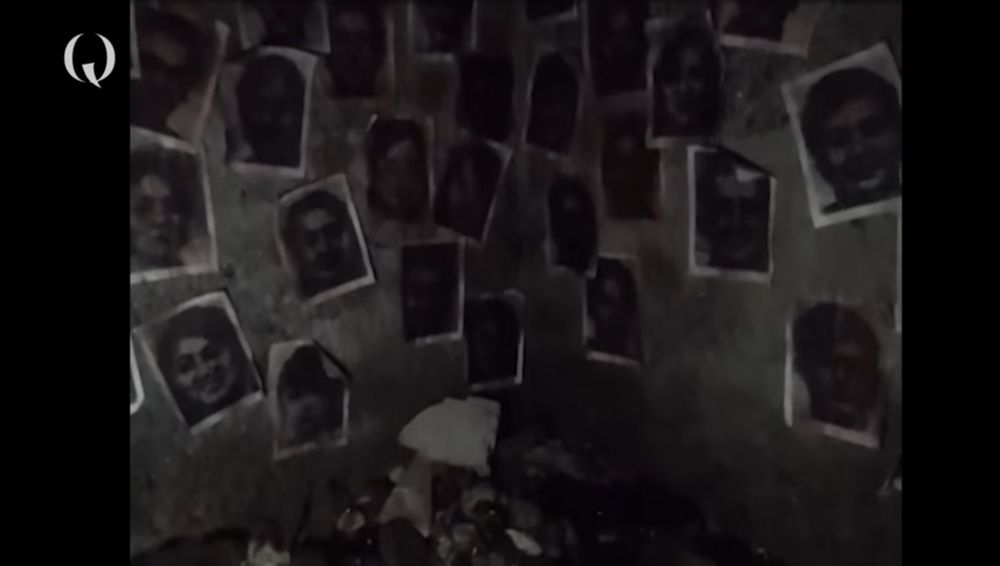 drawings of faces on a dirty wall