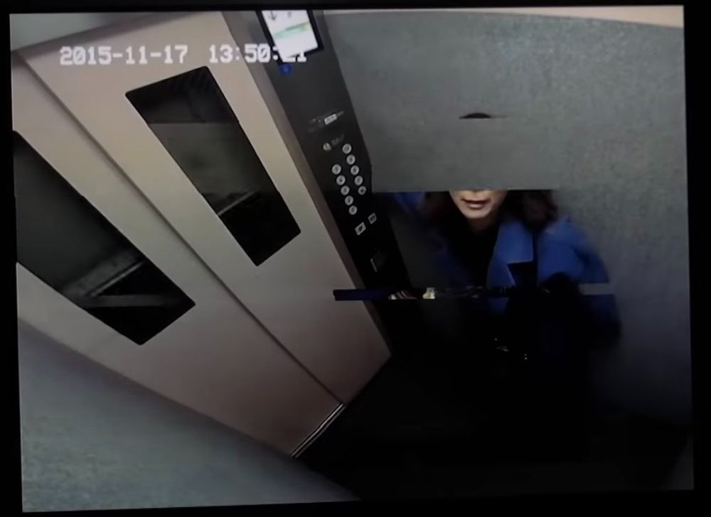 a woman on an elevator. her face is disappearing in a glitch