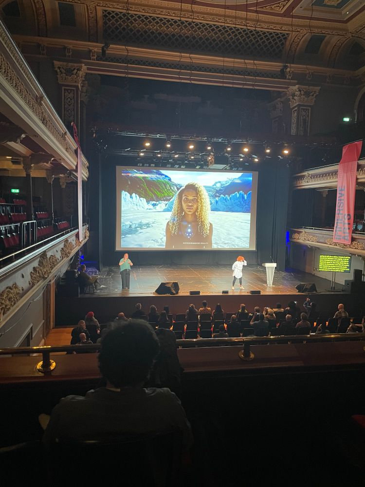 A woman speaking on a stage