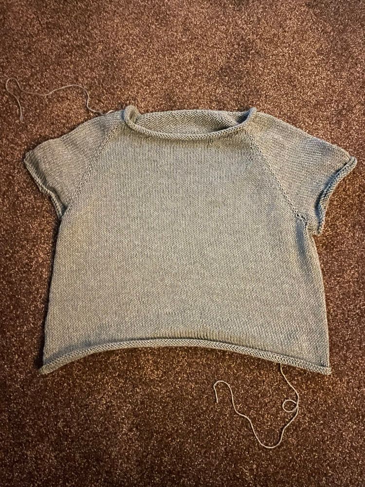 A grey cotton raglan sleeve tee shirt with rolled hems 