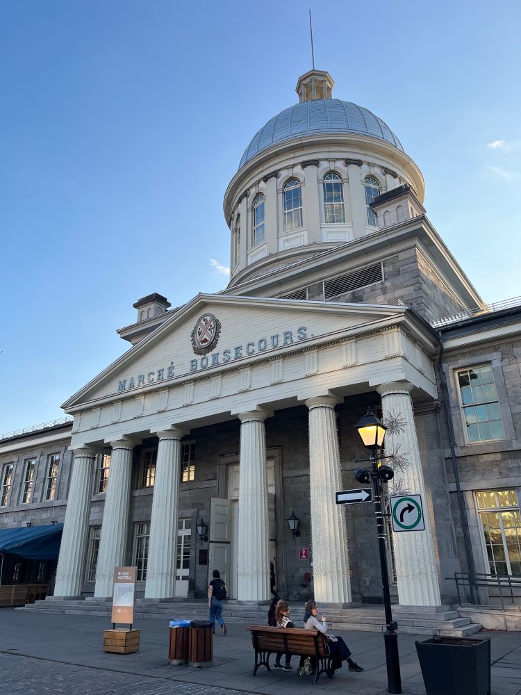 Exterior of old stone building with pillars before the entrance: Marche Bonsecours.