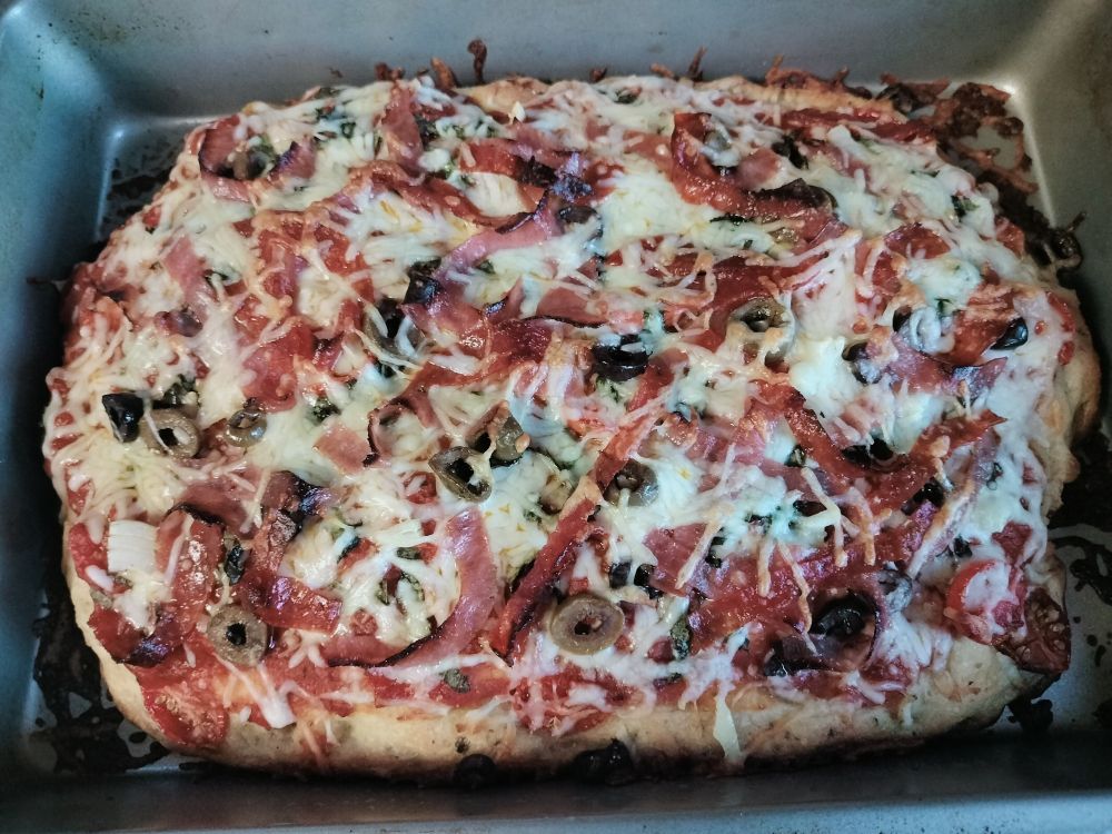 The focaccia pizza I made last week with pepperoni, salami, variety of sliced olives, halved cherry tomatoes, mozzarella and Parmesan. We ate it all and now I'm daydreaming about making more...