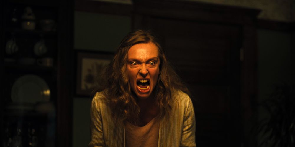 Toni Collette contorting her face while screaming at her son in Hereditary (2018).