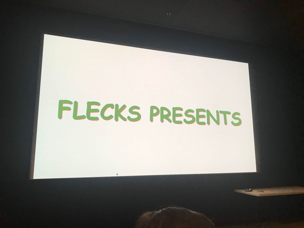 A movie screen with the words “Flecks Presents”.
