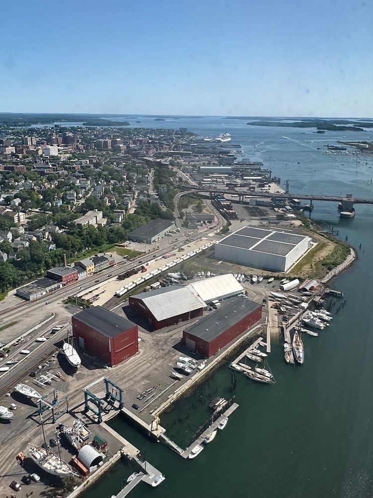 A view of the Portland waterfront from the air. Looking down Commercial Street. Portland Yacht Services is in the foreground with the new big freezer place. A cruise ship can be seen docked at Ocean Gateway at the other end of the street. 