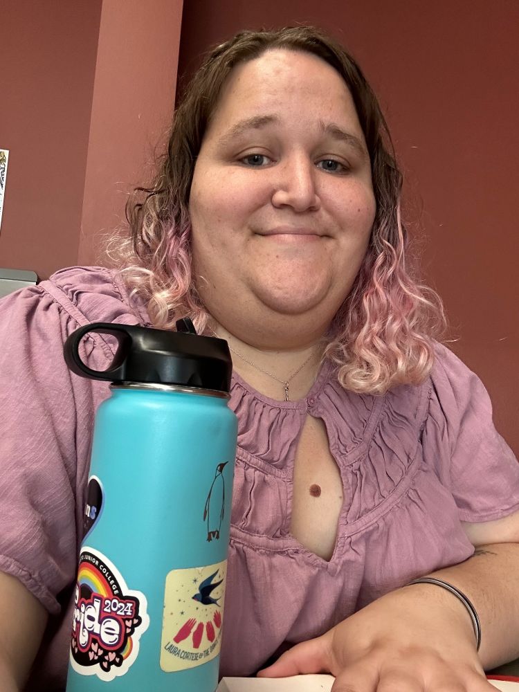 A selfie of me with my light blue water bottle 