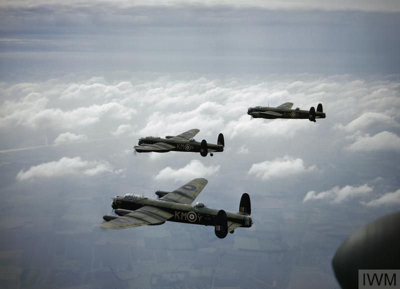(Formation of three RAF 4-engined, twin tailfin heavy bombers at medium altitude over countryside, with scattered white clouds)

Lancasters of 44 Squadron, based at Waddington, on 29th September 1942. The rearmost aircraft (W4187) was lost two nights later on a raid to Wismar, the entire crew being killed.
📷 IWM TR 197