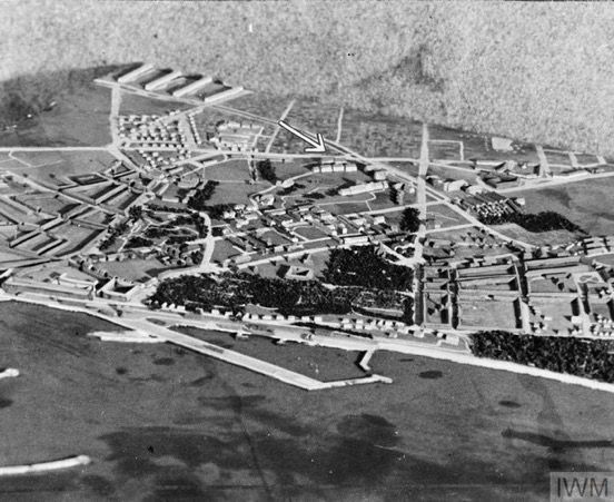 Detailed model of Aarhus, produced to aid 140 Wing crews prior to the raid. The target buildings are indicated by a white arrow. The image shows an intricate 3-D representation of the target area, a coastal town with a harbour. Everything is included - streets, individual buildings and wooded areas.