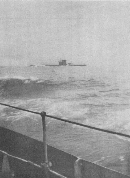 U-Boat on the surface in heavy seas and poor visibility, viewed from another vessel.