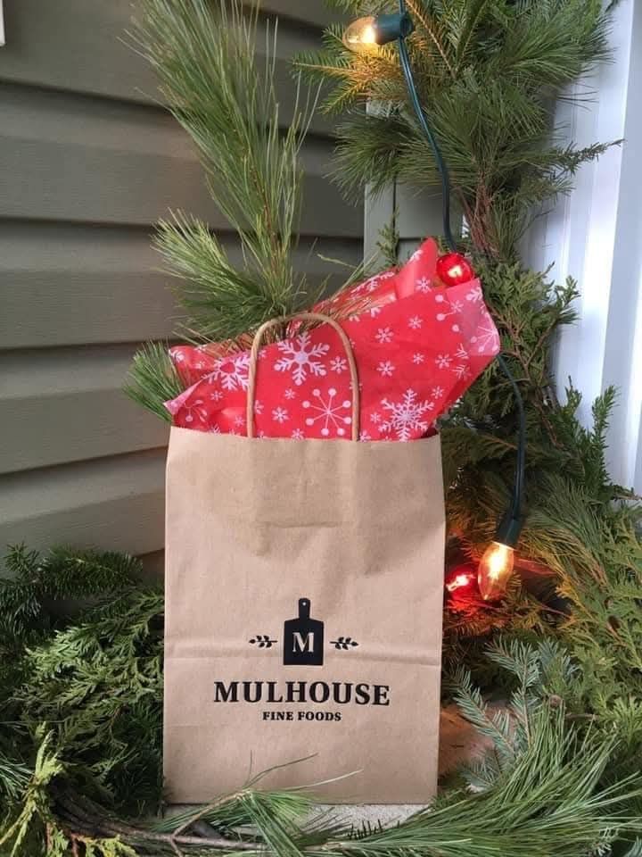 A paper bag filled with cheese, wrapping paper and pine. Only available at the Boyce Farmers Market.
