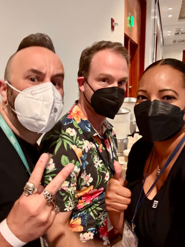 Three masked scientists at a DevBio conference 