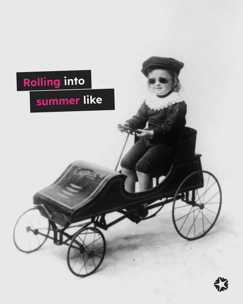 Vintage photo of a child in a toy car wearing driving goggles, a hat and white lace neck ruffle text overlayed "Rolling into summer like"