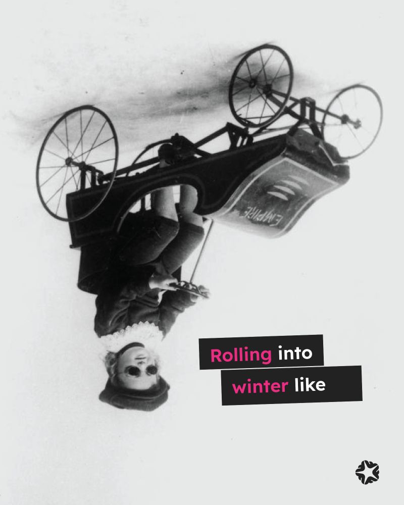 Upside down vintage photo of a child in a toy car wearing driving goggles, a hat and white lace neck ruffle text overlayed "Rolling into winter like."