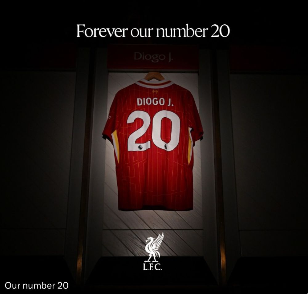 A red Liverpool FC football jersey with the name "DIOGO J." and the number 20 hangs in a locker, illuminated by a spotlight. Above the jersey, the text reads "Forever our number 20" in white letters. The Liverpool FC (L.F.C.) crest is displayed at the bottom of the image with “Our number 20” at the bottom left. 
