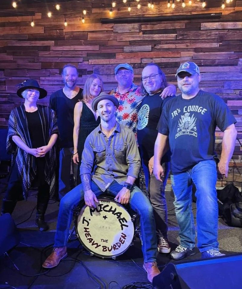 The members of J. Michael & The Heavy Burden stand together.