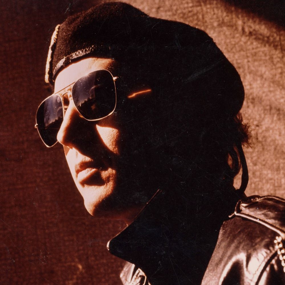 Head shot of Scottt Morgan wearing sunglasses and a beret circa 1980