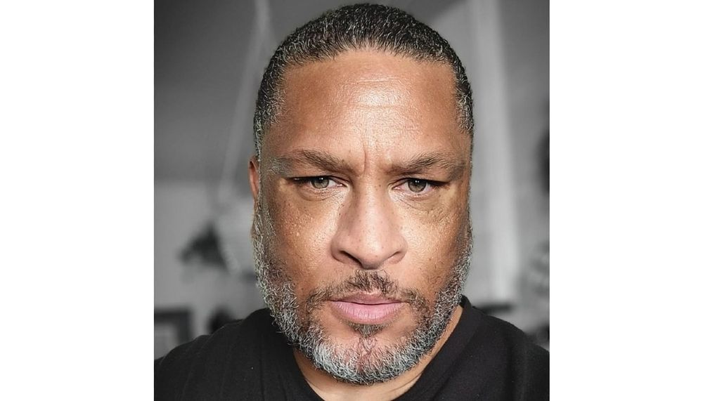 A portrait of Chuck Slay wearing a black shirt.