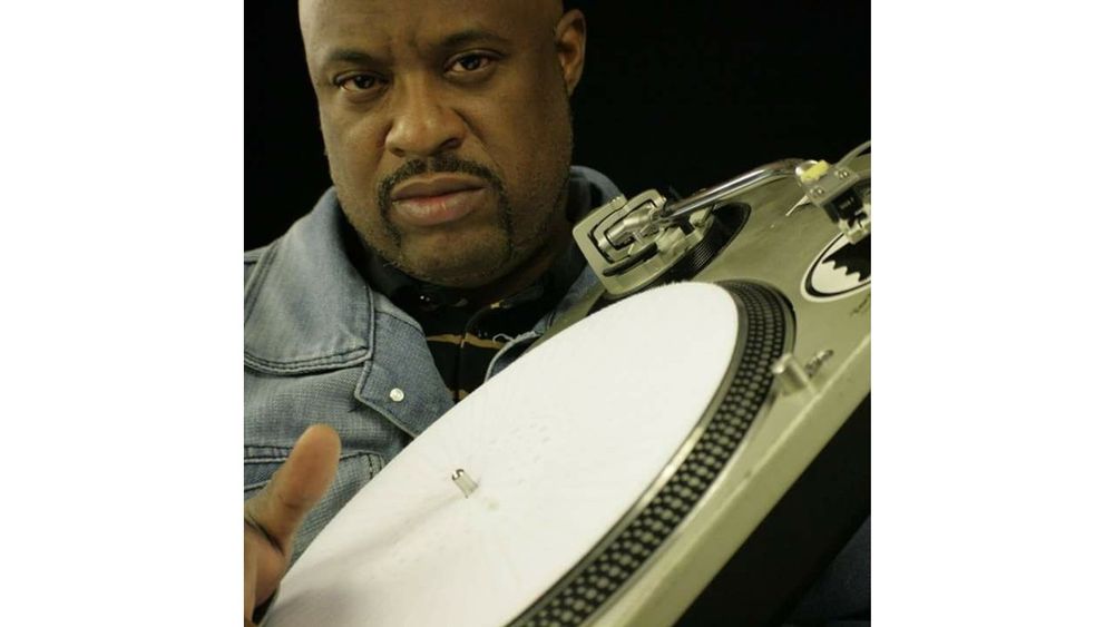 Jamil Powers holds a turntable.