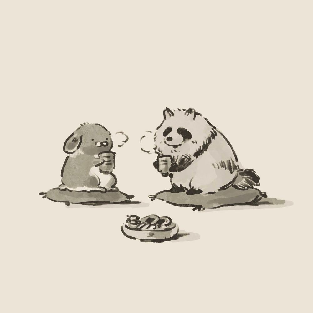うさぎとたぬきが座布団の上で一緒にお茶を飲んでいるイラスト
