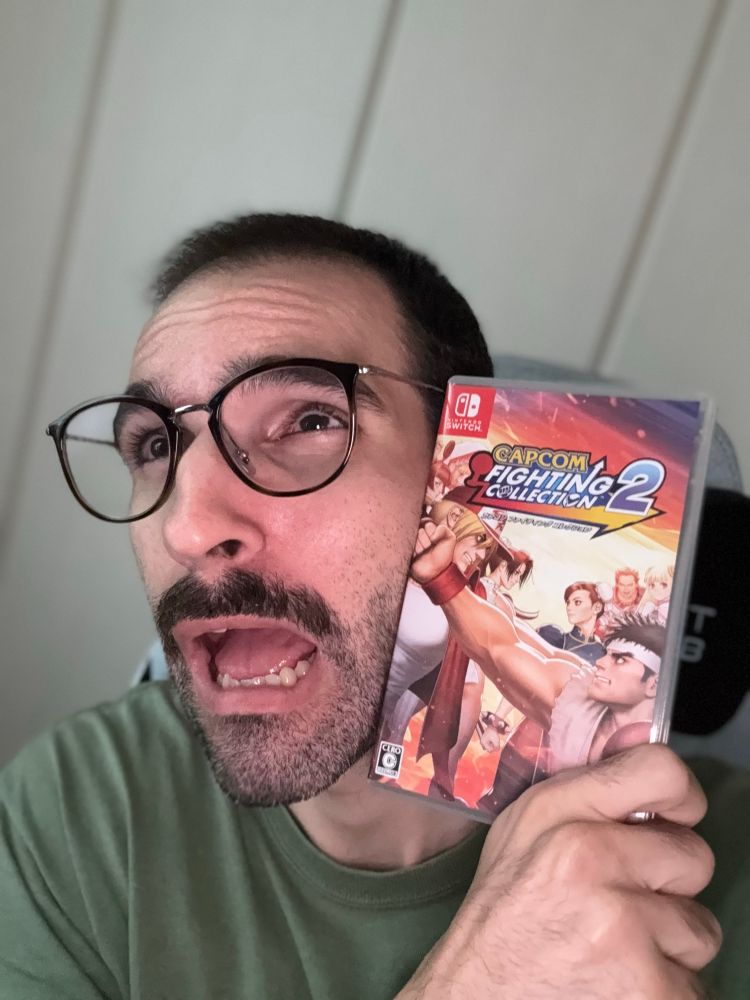 Selfie where I’m holding the box for Capcom Fighting Collection 2 against my face so it looks like Ryu is punching me and I’m making a face like I got hit