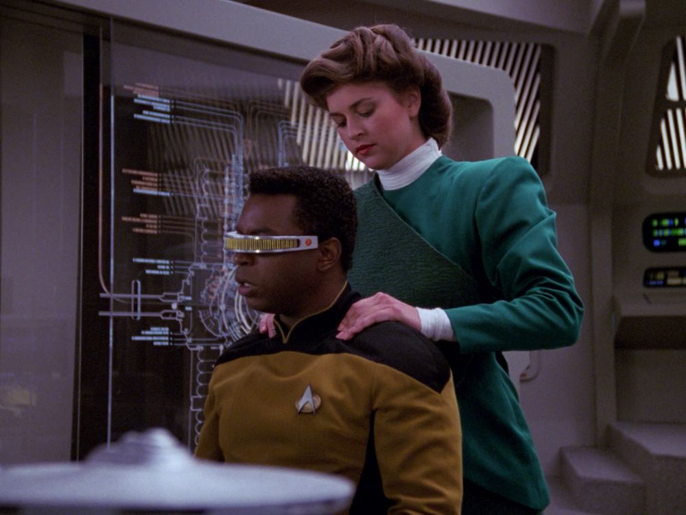 Geordie Le Forge and his hollodeck engine designer/unwitting girlfriend giving him a shoulder massage after he tweaked the program to make her more personable. Unfortunately, your fake gf does not have a real world equivalent to burst your bubble 