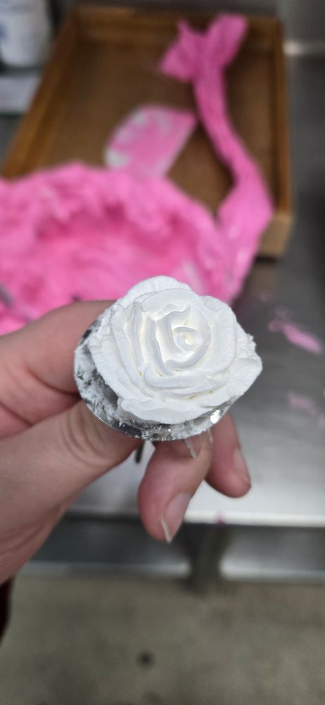 A hand piped whipped cream rose
