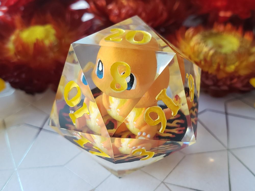 picture of a jumbo D20 with a miniature charmander inside