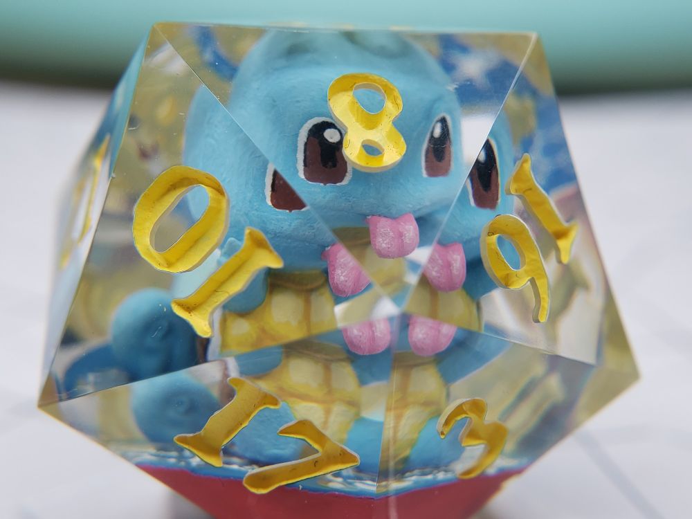 picture of a jumbo D20 with a miniature squirtle inside