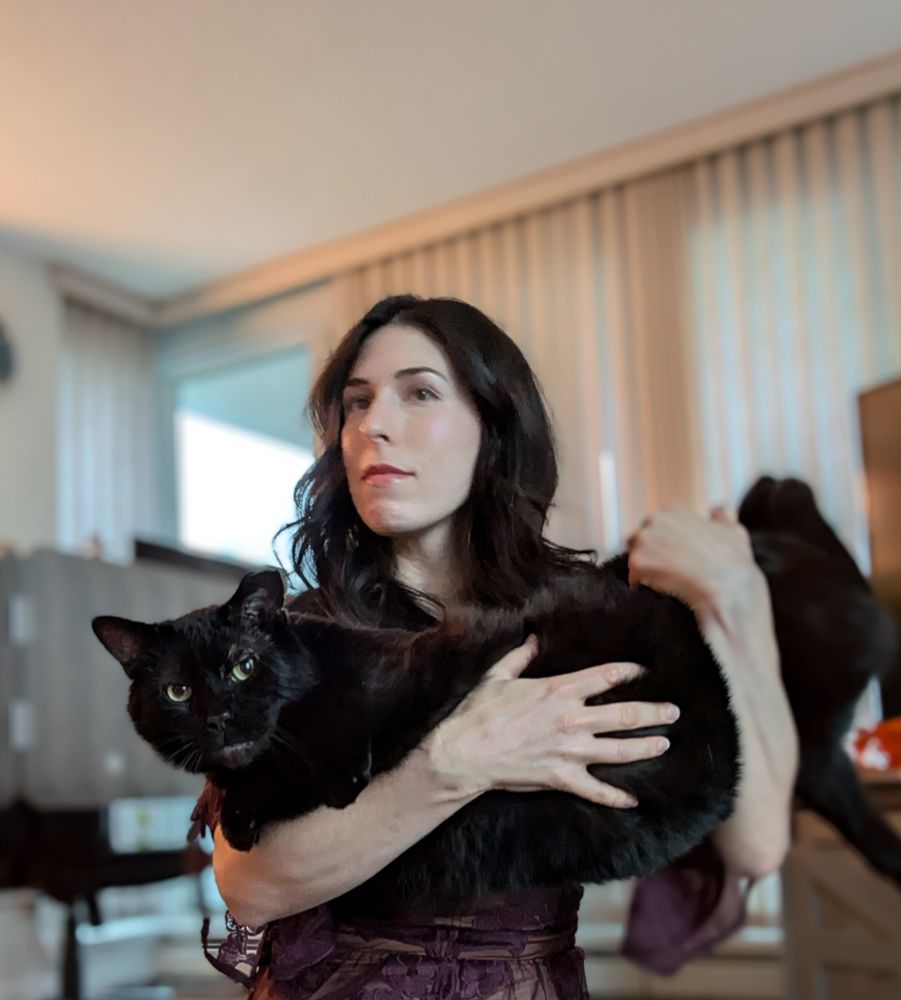 Me a little out of focus holding my enormous black cat Snufkin who - and I cannot stress this enough - is truly huge 