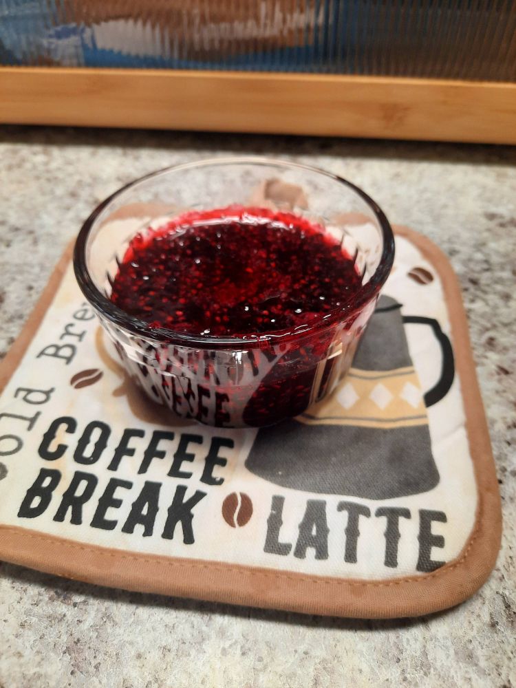 A similar small glass container now filled with homemade dewberry jam