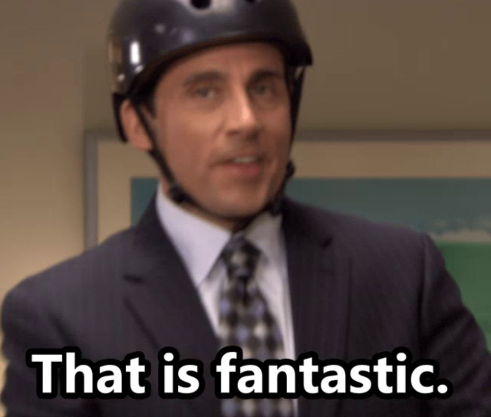 a man in a suit and tie wearing a helmet says " that is fantastic "