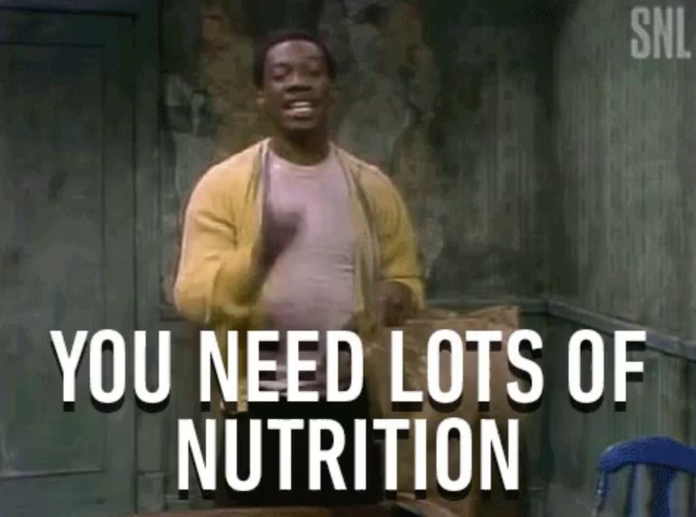 a man in a yellow cardigan is standing in a room with the words `` you need lots of nutrition '' .